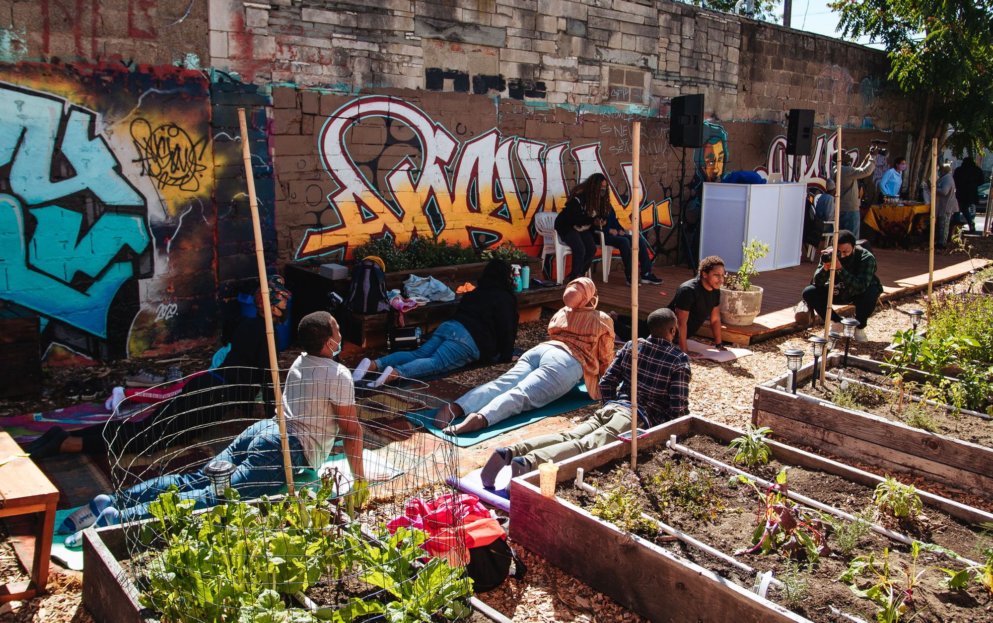 People-in-a-yoga-pose-inside-of-a-urban-garden